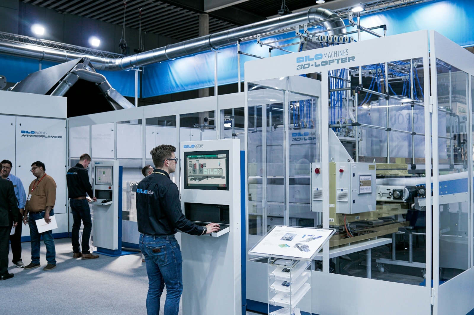 Engineer at a machine control console in an industrial showroom